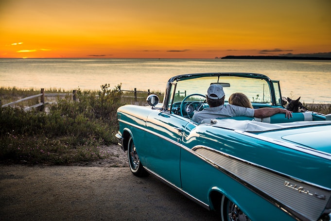 blue bel air car parked in front of sunset