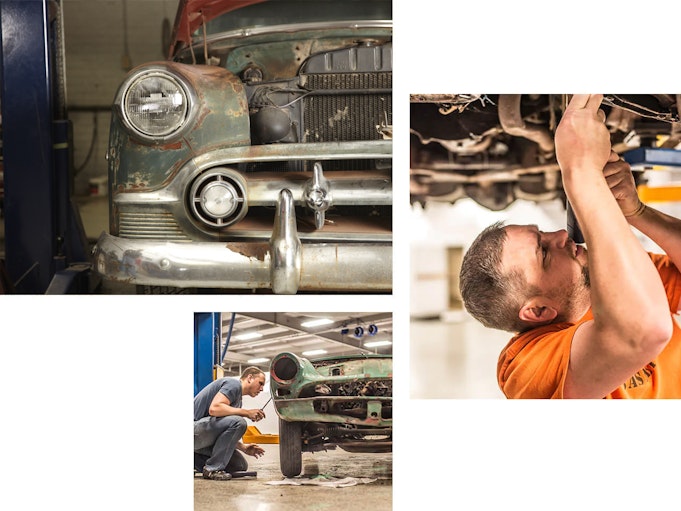 A group of men and women collectively work on restoring a collector vehicle.
