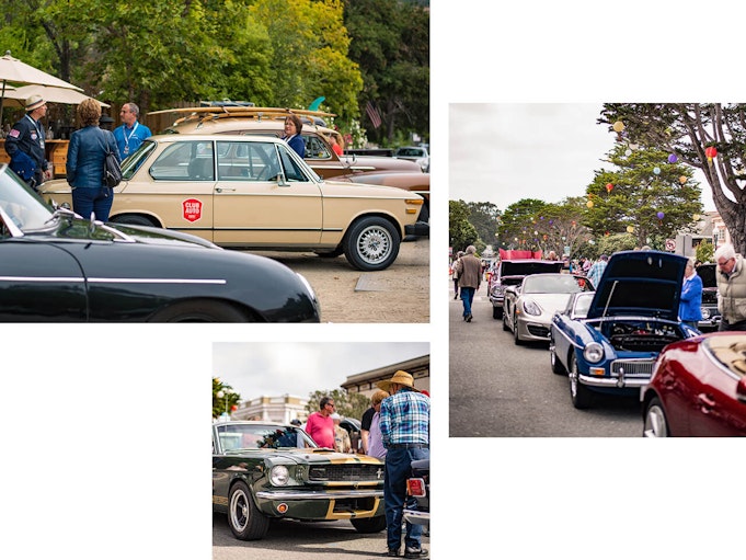 Streets lined with collector vehicles, popped hoods, and people partaking in a car club event.
