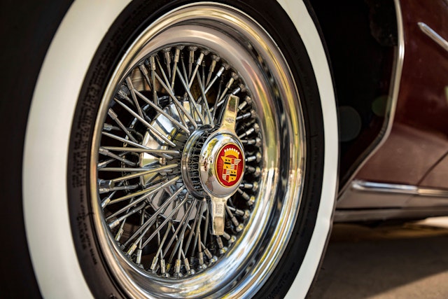 The wheel of a Cadillac with white-wall tires