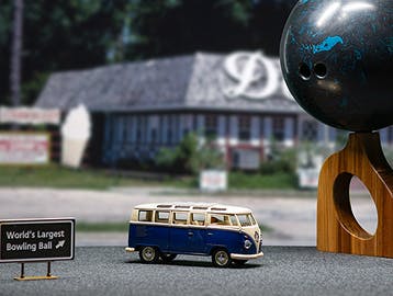 Toy VW van on a road trip next to the "world's largest bowling ball"