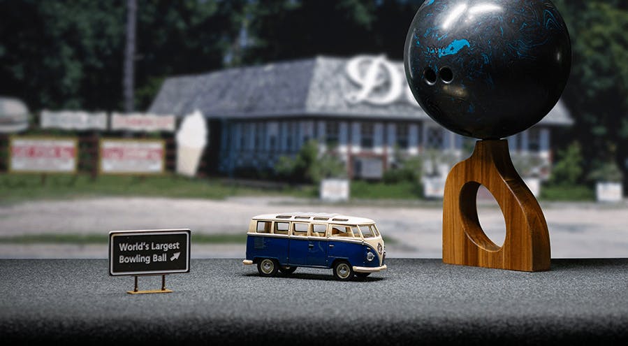 Toy VW van on a road trip next to the "world's largest bowling ball"