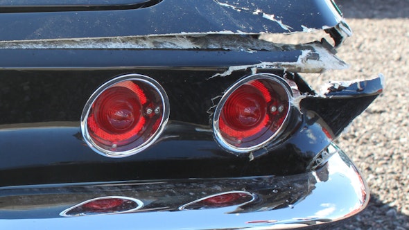 Smashed taillights, rear clip, and rear bumper of a collector Corvette.