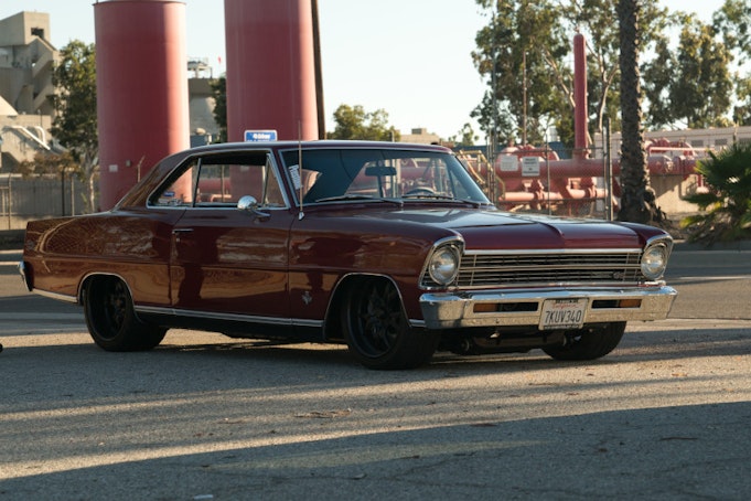 Classic Chevy Nova parked in industrial area