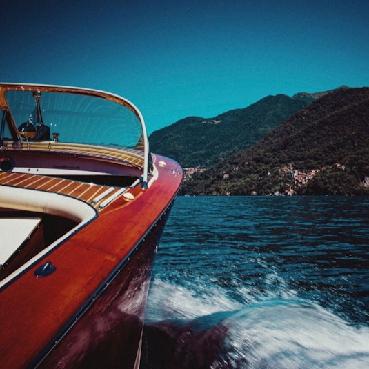 A shoreline view from a classic wooden boat