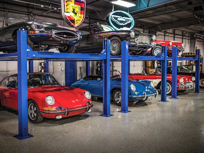 Rare and high value collector vehicles showcased in a garage.