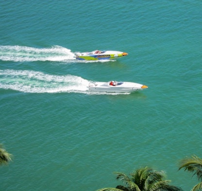 An overhead view of two cigarette boats cruising side-by-side